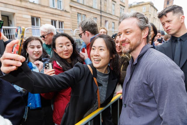 James McAvoy posing for a selfie with fans