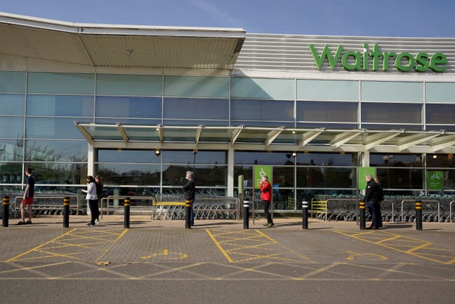 People observe social distancing while queuing at a Waitrose (Morgan Harlow/PA Wire)