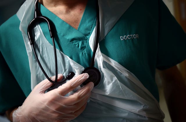 A junior doctor holding his stethoscope (Hanna McKay/PA)
