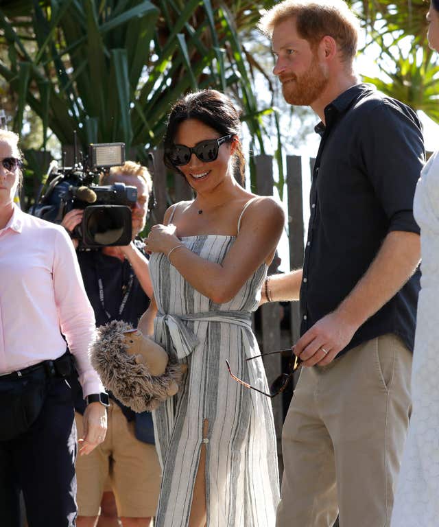 Meghan holds a soft toy - a gift from a member of the public during a visit to Fraser Island, Queensland, during their tour of Australia