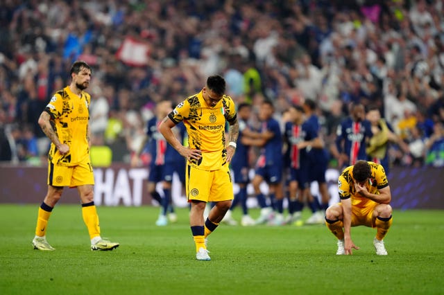 Inter Milan’s Lautaro Martinez and team-mates appear dejected as Paris St Germain players celebrate in the background