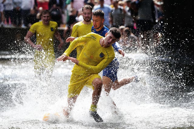 Annual football game in the river