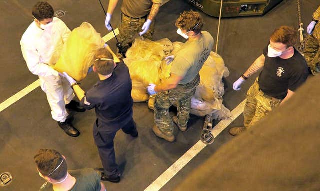 Sailors and Royal Marines off-loading the drugs following the seizure