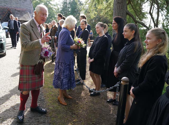 The King and Queen meet estate staff and members of the public as they leave Crathie Parish Church, near Balmoral, after a church service to mark the first anniversary of the death of Queen Elizabeth II