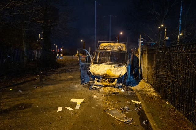 A burnt out police van after a demonstration outside the Suites Hotel in Knowsley (Peter Powell/PA)