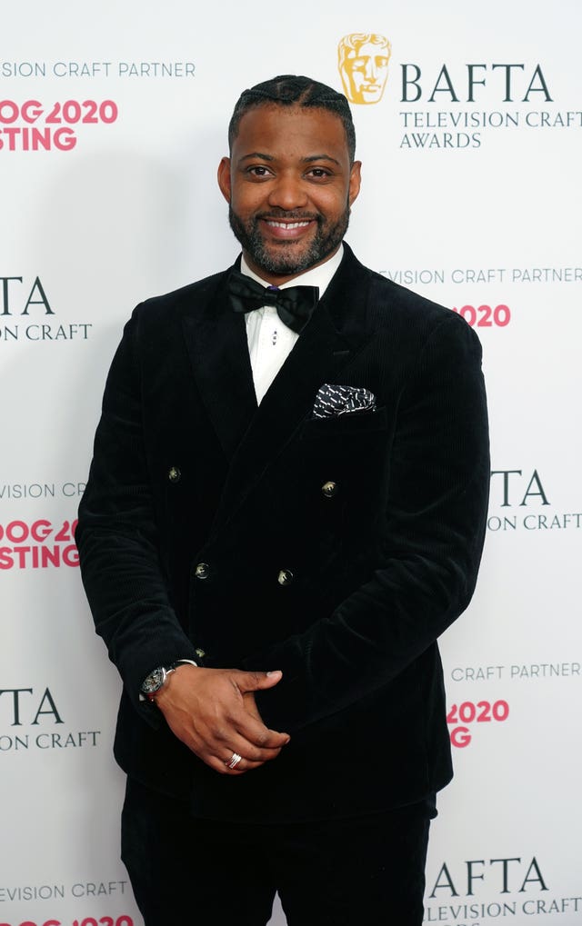 JB Gill in front of Bafta Television Craft Awards backdrop