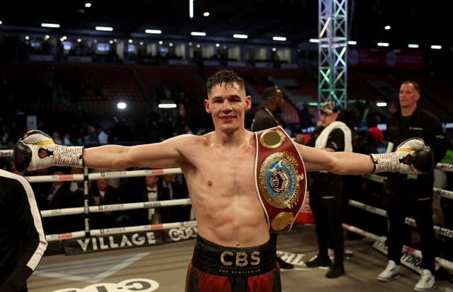 Chris Billam-Smith raises his arms to celebrate after his victory against Lawrence Okolie