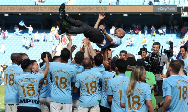 Manchester City manager Pep Guardiola is thrown up into the air by players as they celebrate the 2017-18 Premier League title