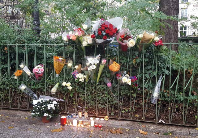 Candles and flowers opposite the Bataclan concert hall in Paris (Catherine Wylie/PA)