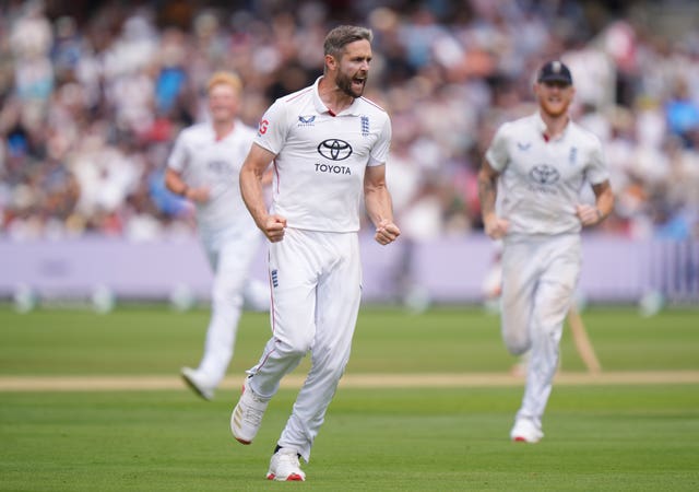 Chris Woakes celebrates taking a wicket for England