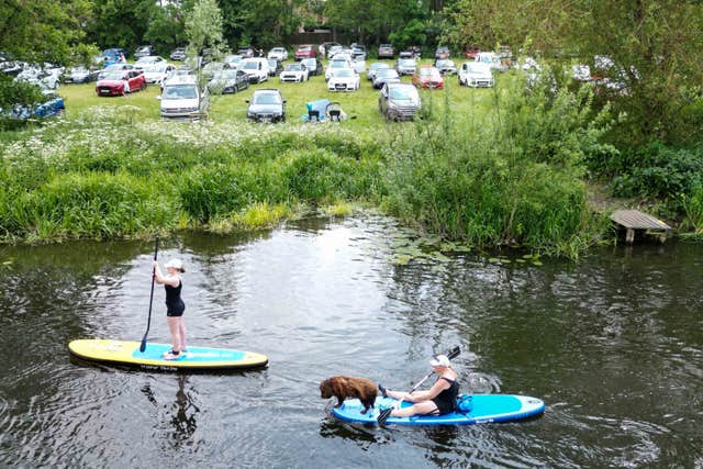 People paddle boarding on river in Warwick