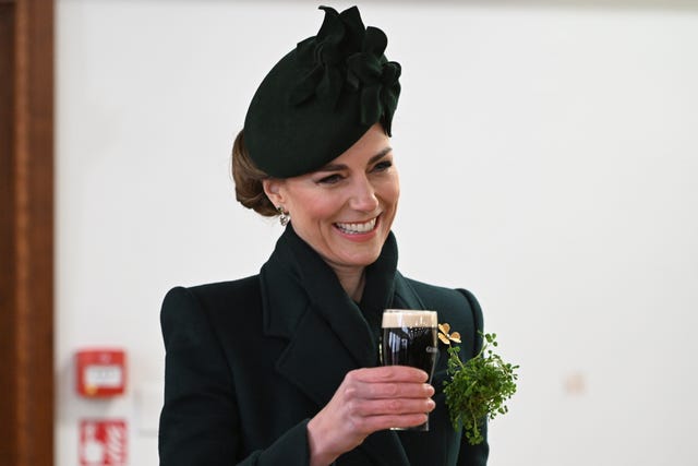 The Princess of Wales enjoys a glass of Guinness during the visit to the Irish Guards