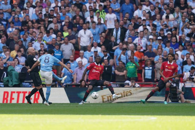Ilkay Gundogan, second left, scores his and Manchester City’s second goal in the FA Cup final