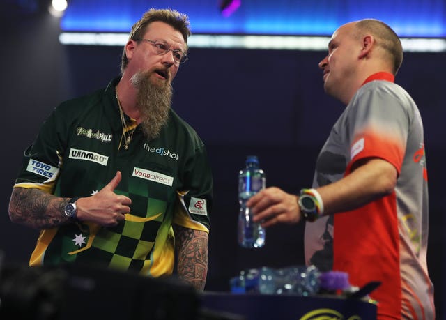 Simon Whitlock (left) talks to Darius Labanauskas after his win at Alexandra Palace