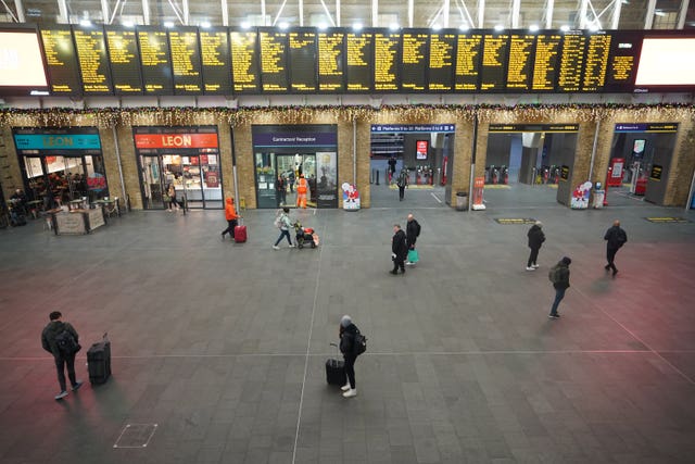 Passengers at King's Cross Station in London during strike action by members of the Rail, Maritime and Transport union in December 