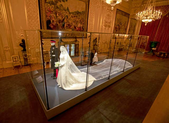 Harry's wedding outfit is featured alongside his wife's wedding dress. Steve Parsons/PA Wire