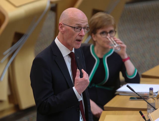 Education Secretary, John Swinney gives a statement on SQA exam results at the Scottish Parliament, watched by First Minister Nicola Sturgeon