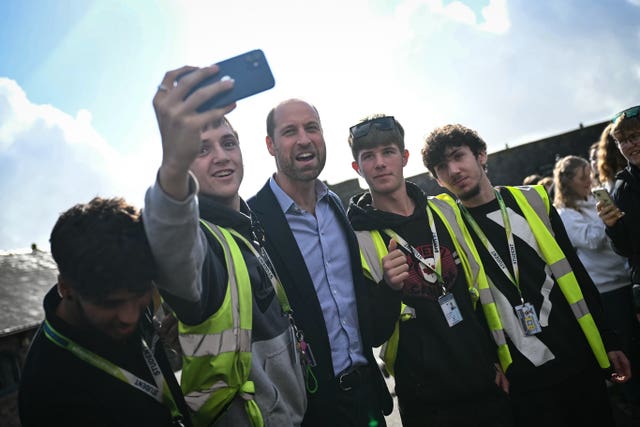 Students take a selfie with Prince William