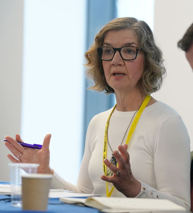 Audrey Nicoll gestures as she speaks while sat at a table 