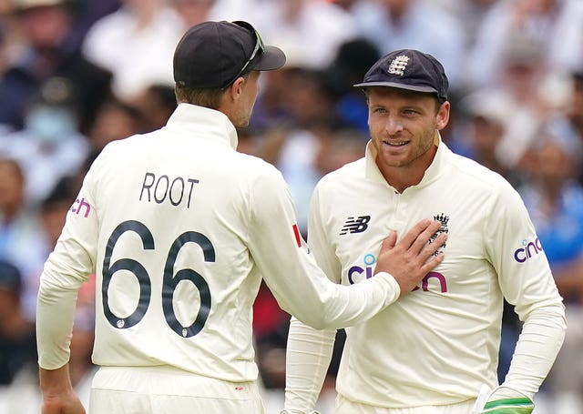 Joe Root pats Jos Buttler on the chest on England Test duty.