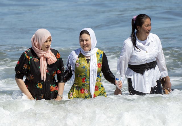 People enjoying the warm weather on Scarborough beach, North Yorkshire