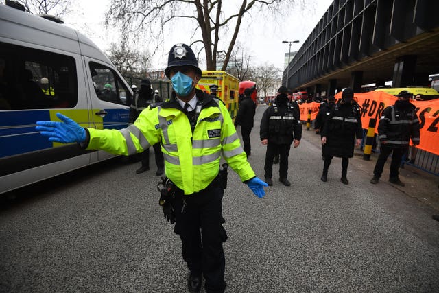 Officers from the Metropolitan Police and the National Eviction Team (NET) block the entrance to the anti-HS2 camp at Euston Square Gardens, London (Victoria Jones/PA)