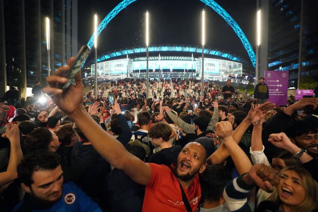England fans celebrate outside Wembley Stadium after England qualified for the Euro 2020 final