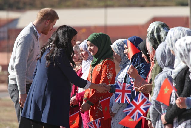 Meghan greeting school children