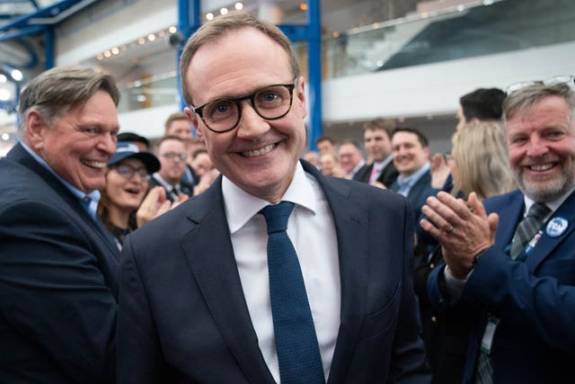 Tom Tugendhat smiles as he is applauded by crowds