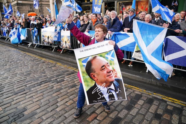 Mourners stand outside an Alex Salmond memorial service