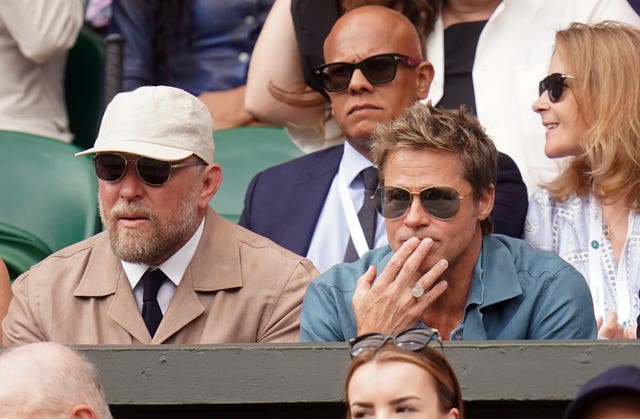 Brad Pitt (right) and Guy Ritchie (left) were absorbed in Djokovic v Alcaraz