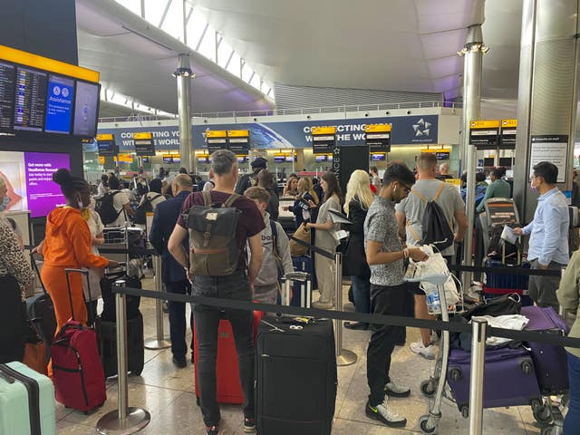 Passengers queue to check-in at Terminal 2 at Heathrow Airport