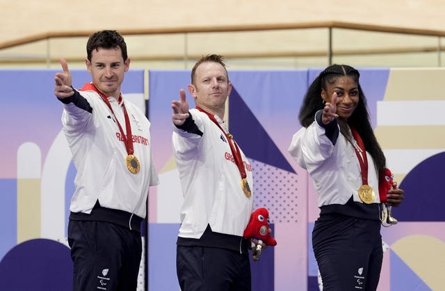 Great Britain’s Jaco van Gass, left, Jody Cundy and Kadeena Cox retained their Paralympics team track cycling C1-5 title in Paris