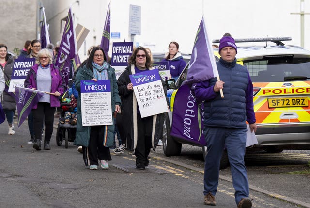 Unison members, with flags, walking along a street