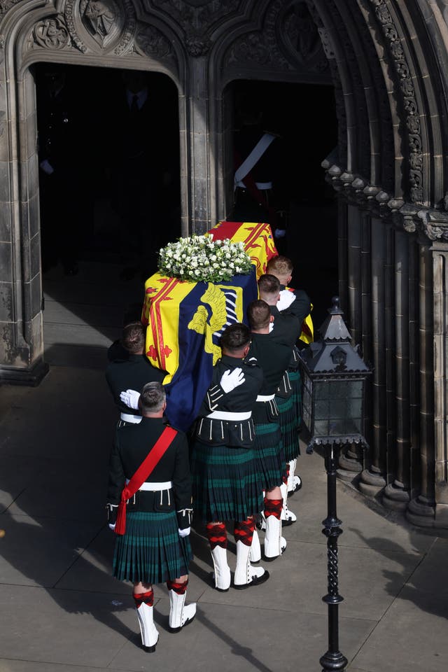 Royal guards carry the Queen’s coffin into St Giles’ Cathedral