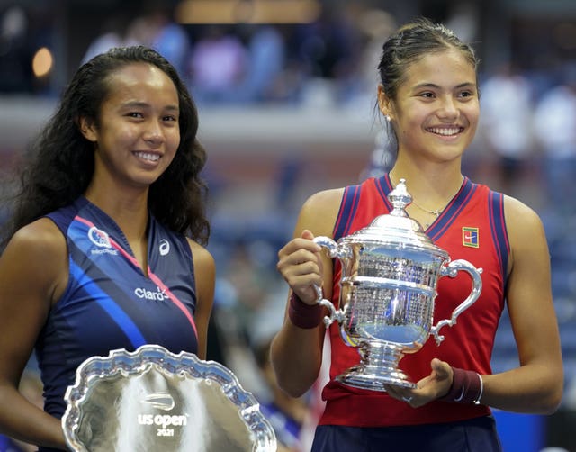 Emma Raducanu, right, and Leylah Fernandez hold their US Open trophies