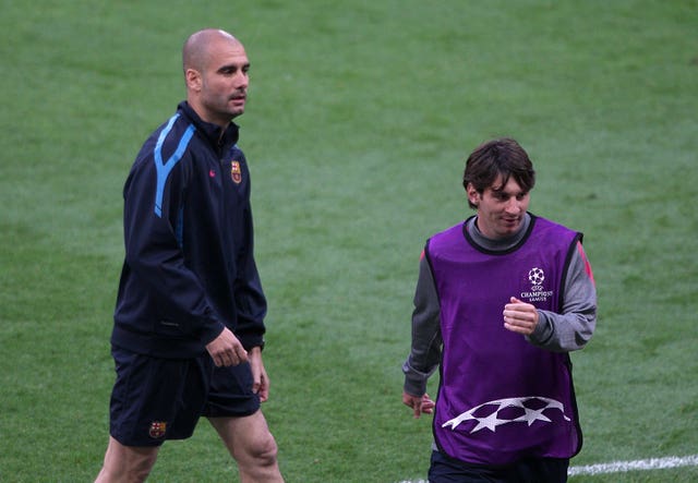 Pep Guardiola and Lionel Messi File Photo