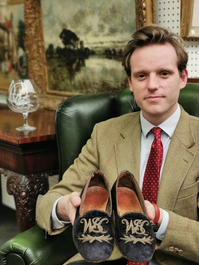 A pair of Winston Churchill’s velvet slippers and brandy glass which have been sold at auction 