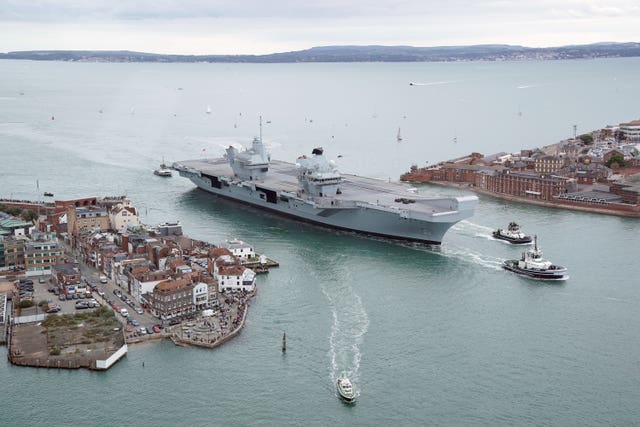 Aircraft carrier HMS Prince of Wales is towed to Portsmouth Naval Base
