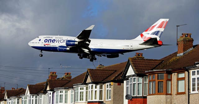 A British Airways Boeing 747 plane lands over houses in Myrtle Avenue near Heathrow airport