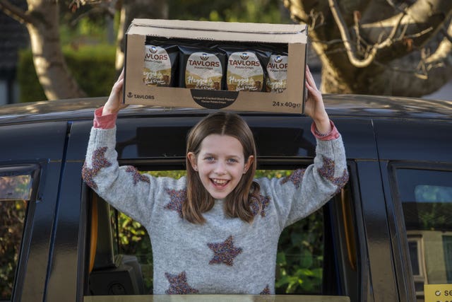 Girl holding a box crisps