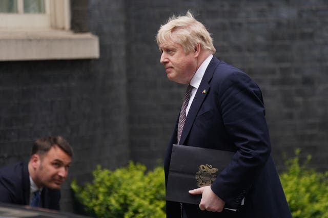 Prime Minister Boris Johnson walks back to 10 Downing Street following a press conference in the Downing Street Briefing Room