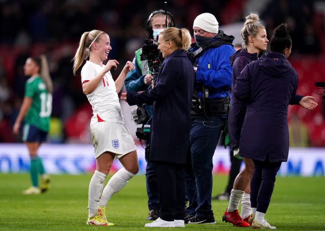 Sarina Wiegman, centre, celebrates with Beth Mead, left, after the win over Northern Ireland