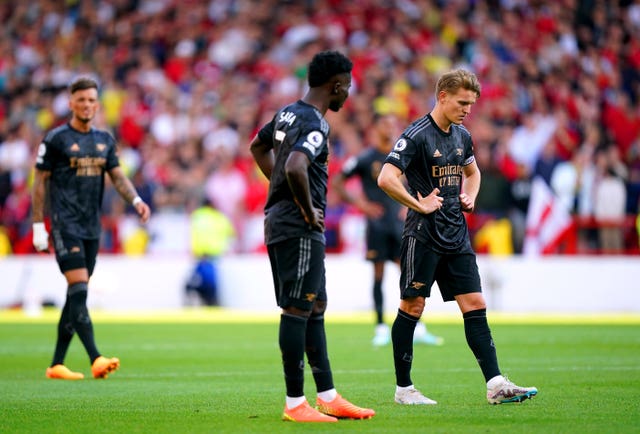 Captain Martin Odegaard, right, appears dejected after Arsenal's title hopes were ended by a 1-0 defeat at Nottingham Forest on the penultimate weekend of the campaign. The Gunners topped the table for much of the season but were ultimately unable to hold off the relentless challenge of Manchester City. Defeat at the City Ground, following Taiwo Awoniyi's first-half finish, left Mikel Arteta's men with just two wins from eight games, a run which included a 4-1 hammering by City