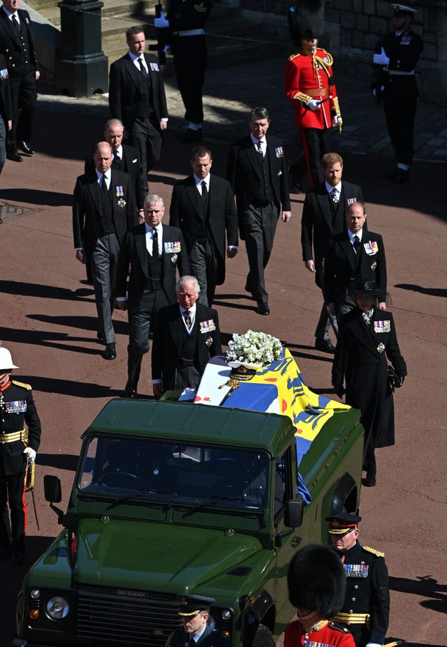 The Duke of Edinburgh’s coffin, covered with his personal standard, is carried on the purpose-built Land Rover Defender followed by the Princess Royal, the Prince of Wales, the Duke of York, the Earl of Wessex, the Duke of Cambridge, Peter Phillips, the Duke of Sussex, the Earl of Snowdon, Vice Admiral Sir Timothy Laurence outside St George’s Chapel, Windsor Castle