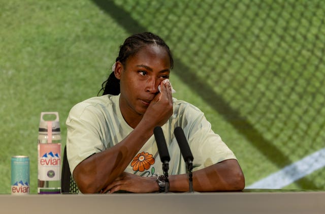 Coco Gauff wipes a tear away during a press conference