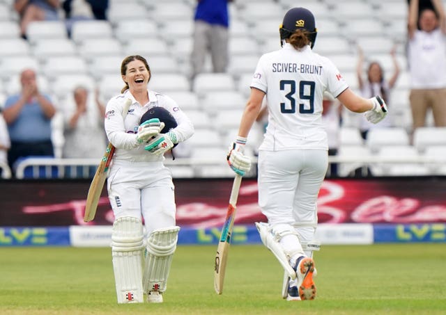 Tammy Beaumont (left) celebrates reaching her century