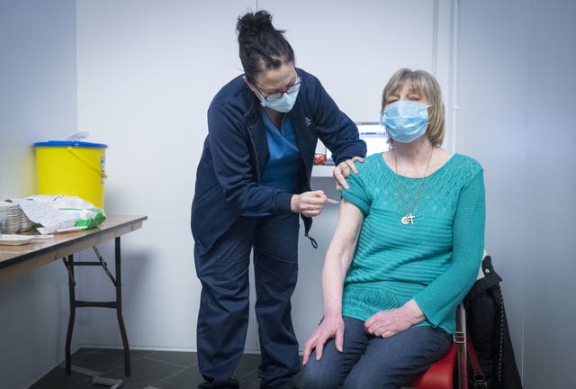 Sarah MacLeod gives Margaret Swift her vaccine