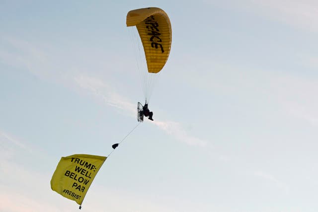 A Greenpeace protester flies over Turnberry
