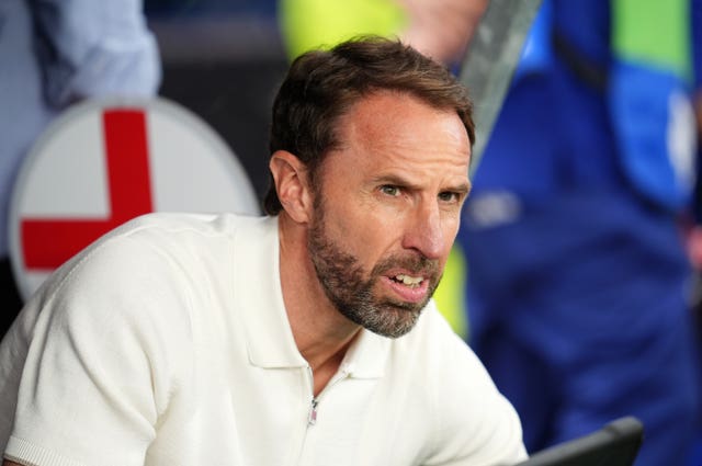 England manager Gareth Southgate sits in the dugout against Denmark